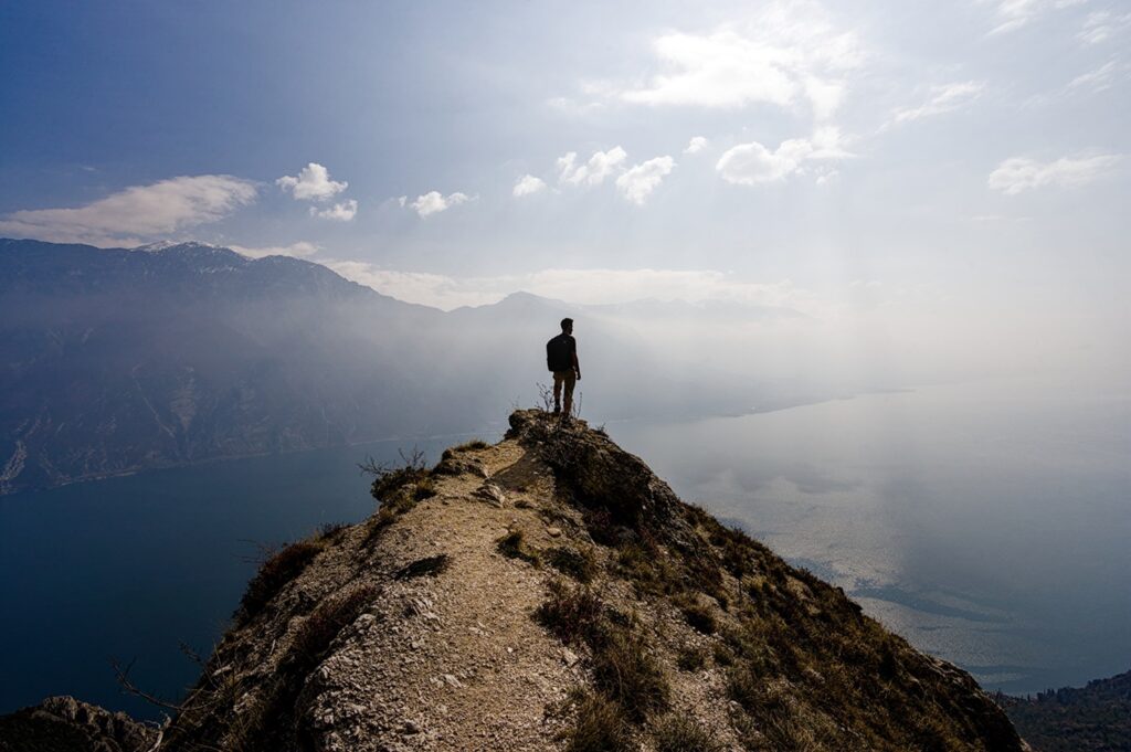 Man,Hiking,On,Top,Of,A,Mountain,And,Enjoying,An