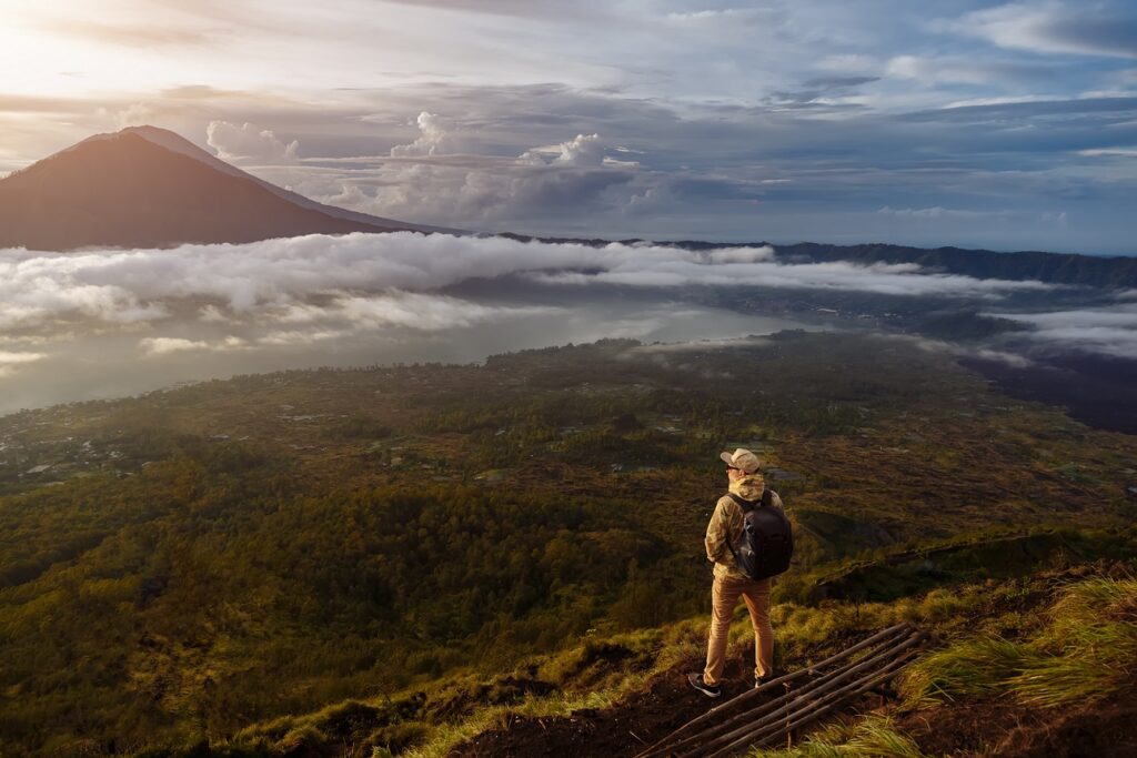 Man,Tourist,Looks,At,The,Sunrise,On,The,Volcano,Batur