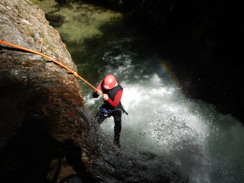Young,Corageous,Girl,Climbing,Down,While,Canyoning,-,Rappeling,Into
