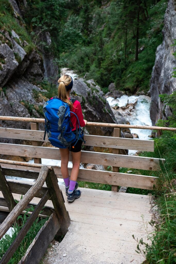 Dachstein,,Austria:,Young,Attractive,Blonde,Woman,Standing,On,A,Bridge