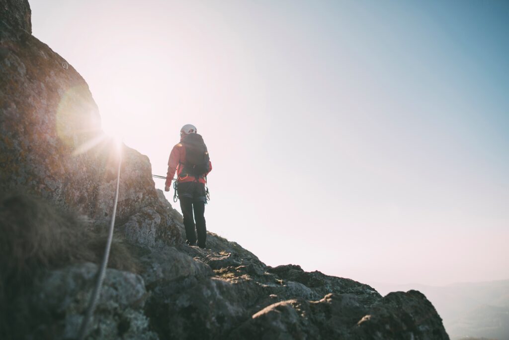 Mountaineer,With,Backpack,Climbing,Along,A,Via,Ferrata