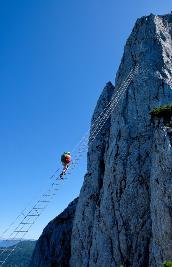 Climbing,A,Diagonal,Via,Ferrata,Ladder,In,Donnerkogel,Mountains,,Austria,