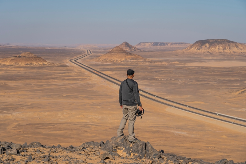 A,Traveller,With,Camera,Standing,On,Top,Of,Mountain,And