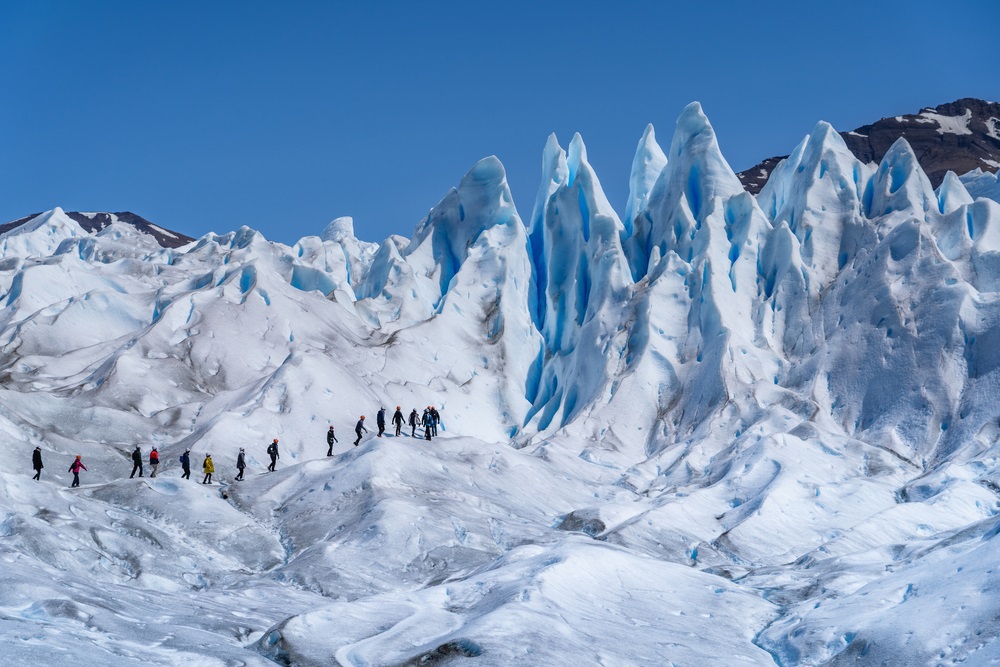Tourists,Ice,Trekking,On,Perito,Moreno,Glacier,In,Los,Glaciares