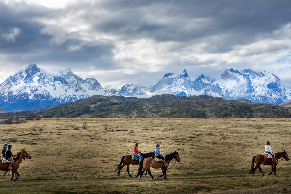 A,Group,Of,People,Horse,Riding,On,A,Field,With