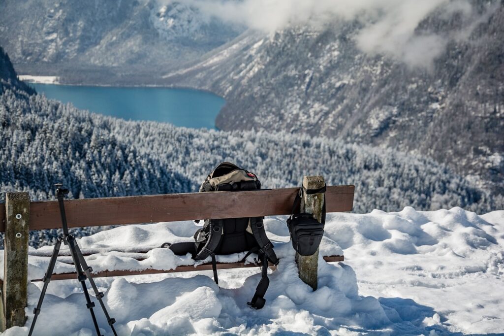 Hiking,Backpack,On,A,Bench,In,Winter,With,Snow,On