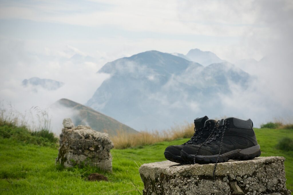 A,Pair,Of,Hiking,Boots,On,Ruins,Of,A,Mountain