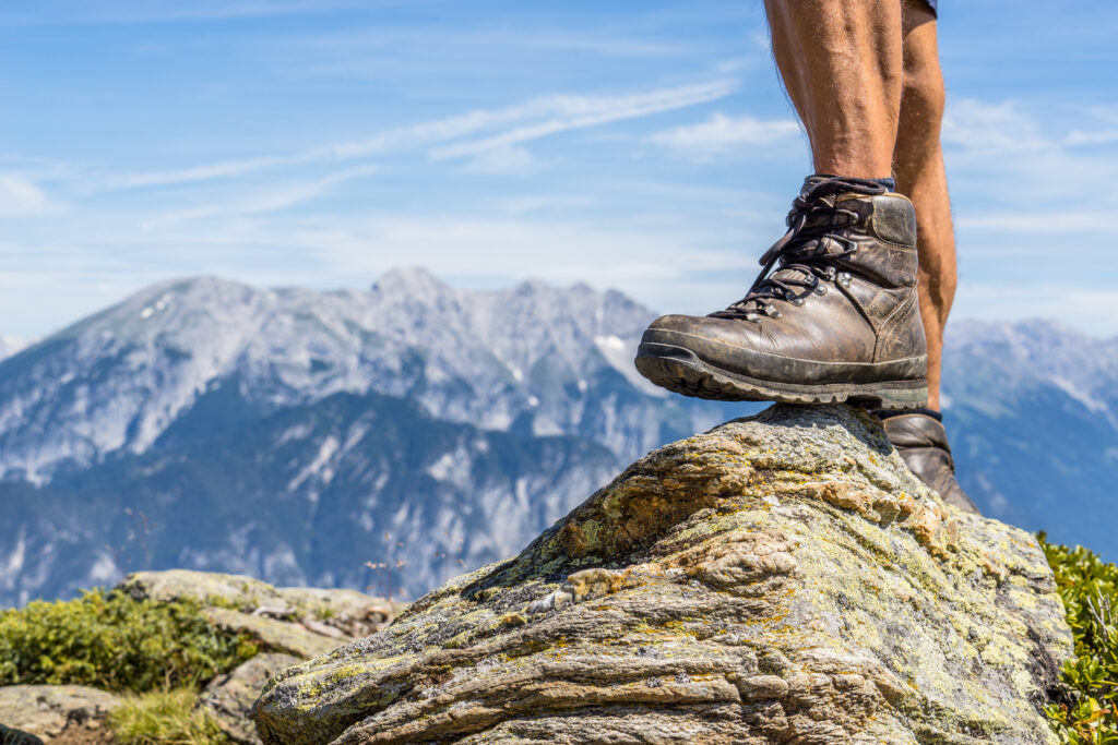 Leather,Hiking,Shoe,Of,A,Man,Stepping,On,A,Small
